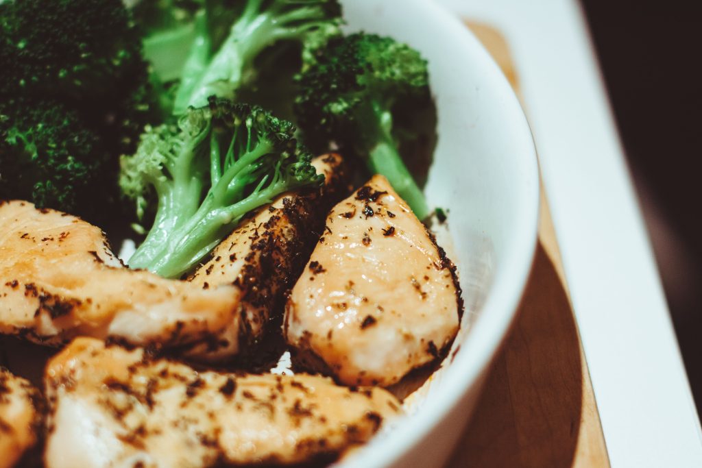 How Much Protein Do You Actually Need Daily? Close-up of a healthy homemade chicken and broccoli dish, perfect for a nutritious meal.